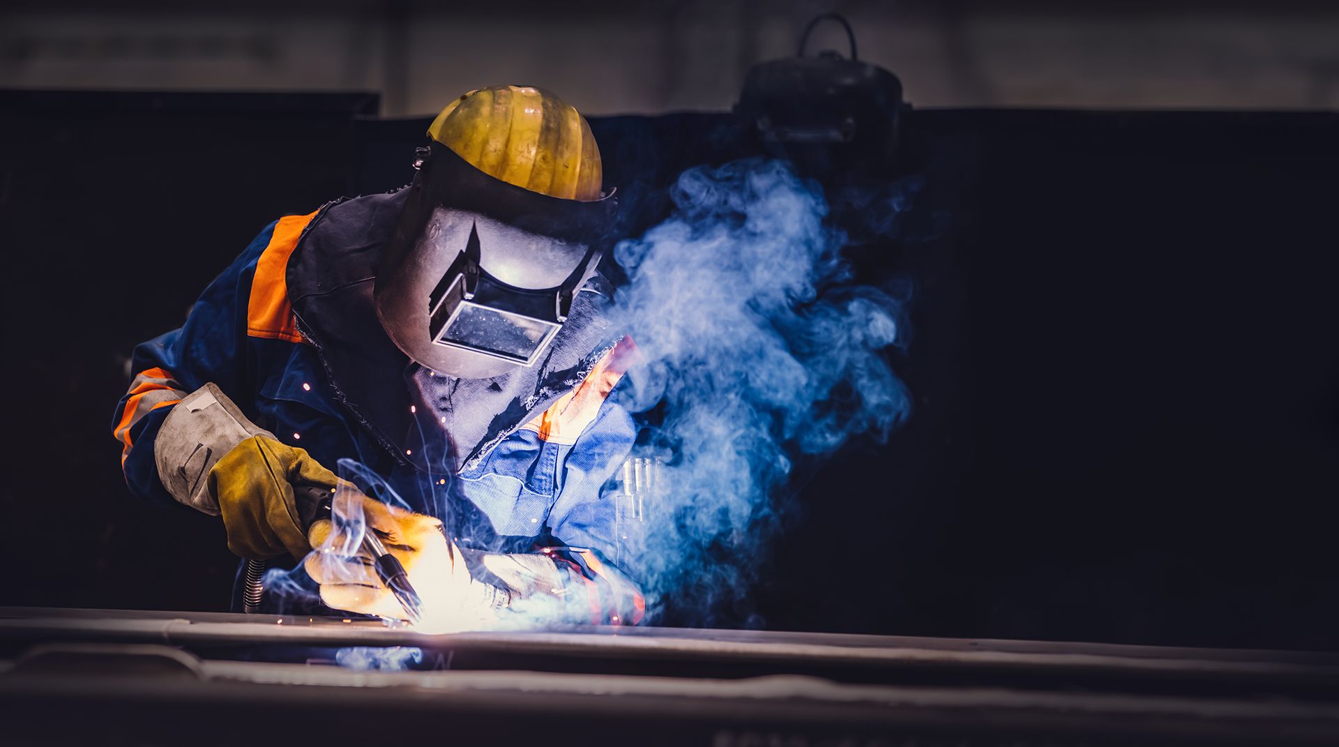 Worker welding in a factory. Heavy industry, welder work